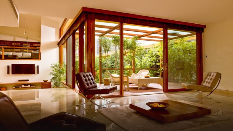 Total Environment - Windmills of Your Mind Apartment & Villa In Bangalore - living room opening into wooden deck